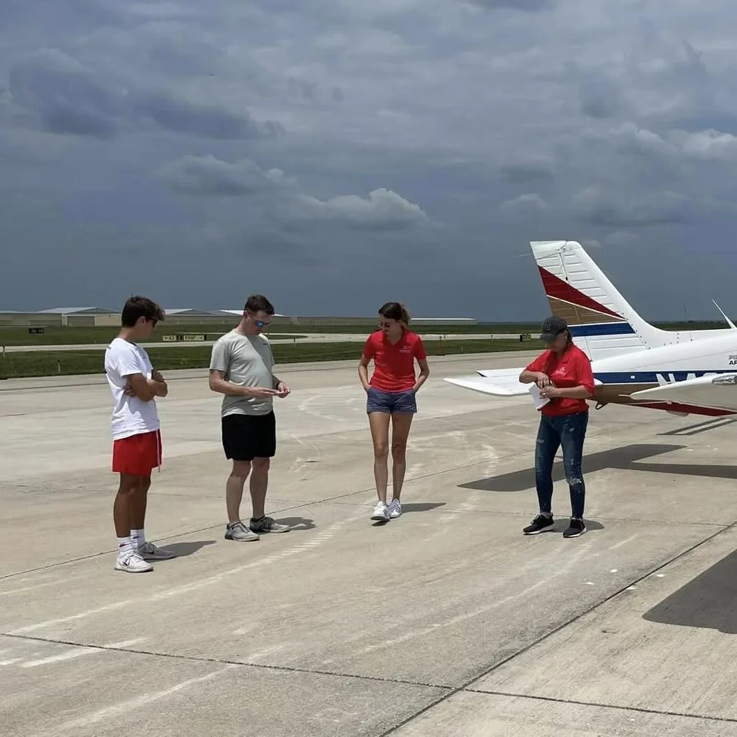 Flight students on the runway pre flight checks