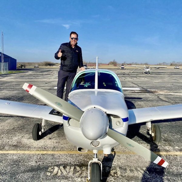 Student pilot smiling inside cockpit after landing at Lee's Summit Airport