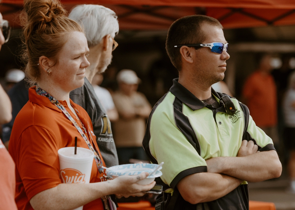 Summit Flight Academy's new hangar groundbreaking ceremony at Lee's Summit Airport, featuring a group of people with shovels and aircraft in the background.