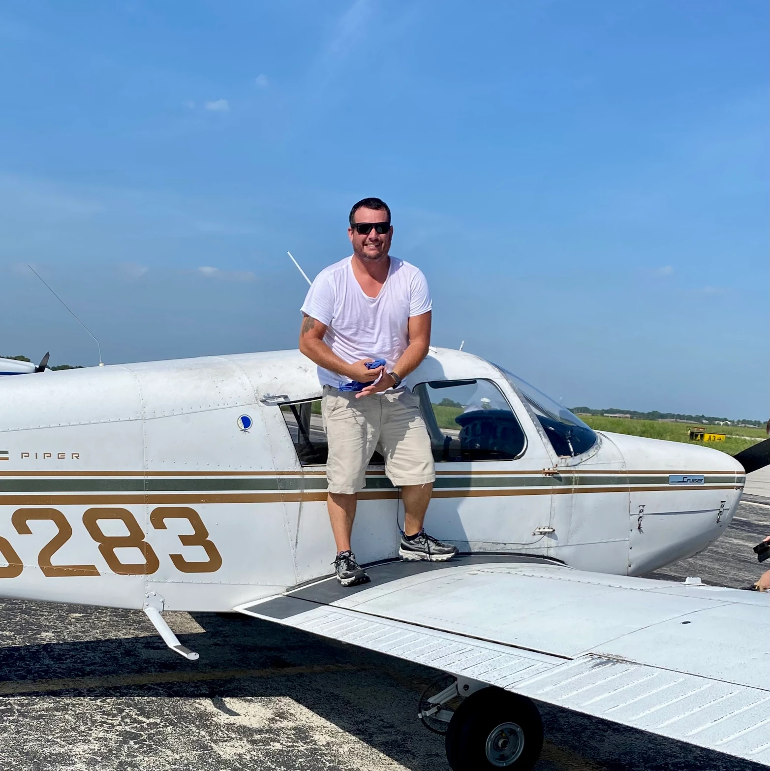 Pilot student standing on an aircraft's right wing