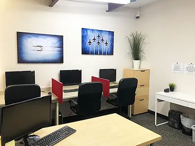 Computer testing stations in a quiet room used for FAA knowledge tests