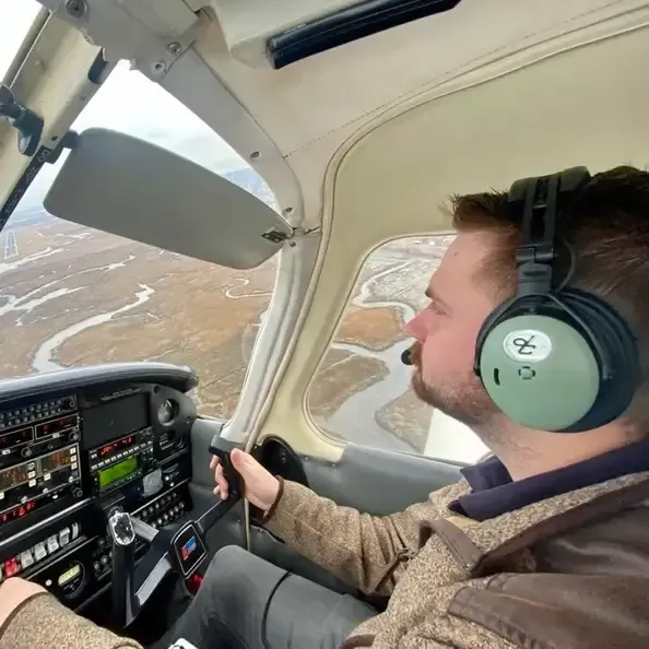 Pilot in the cockpit of a Piper Cherokee flying over Lees Summit Missouri