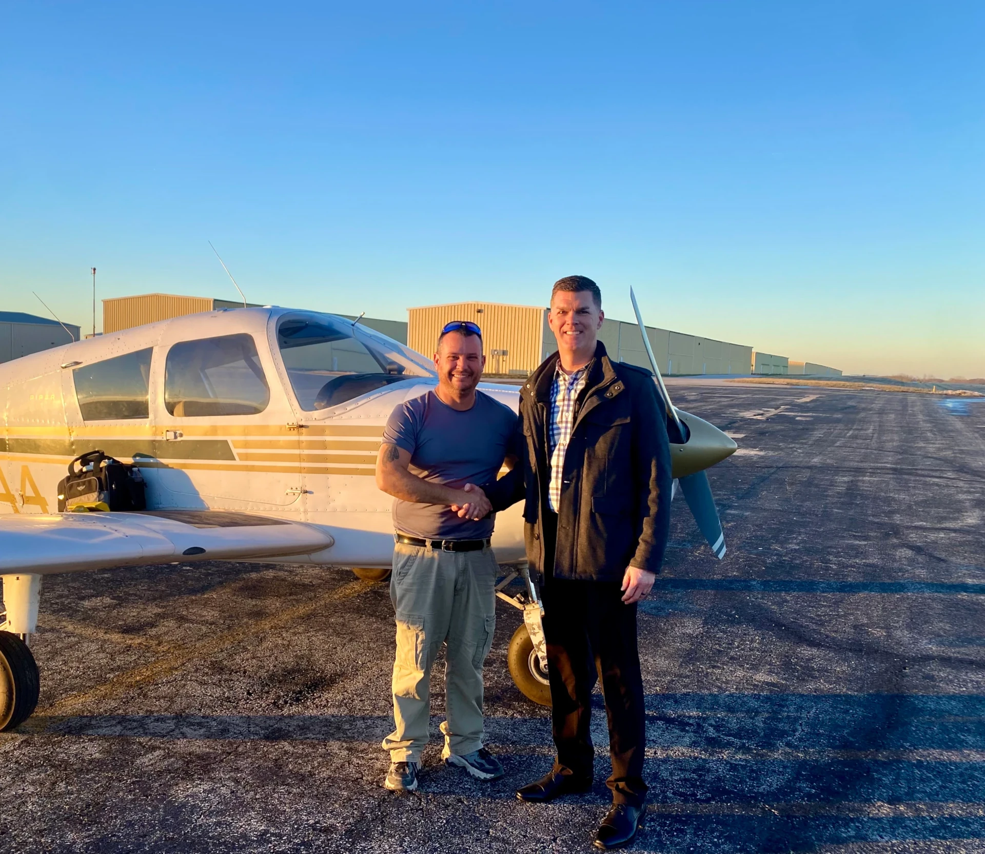 Summit Flight Academy instructor greeting a student beside a training aircraft